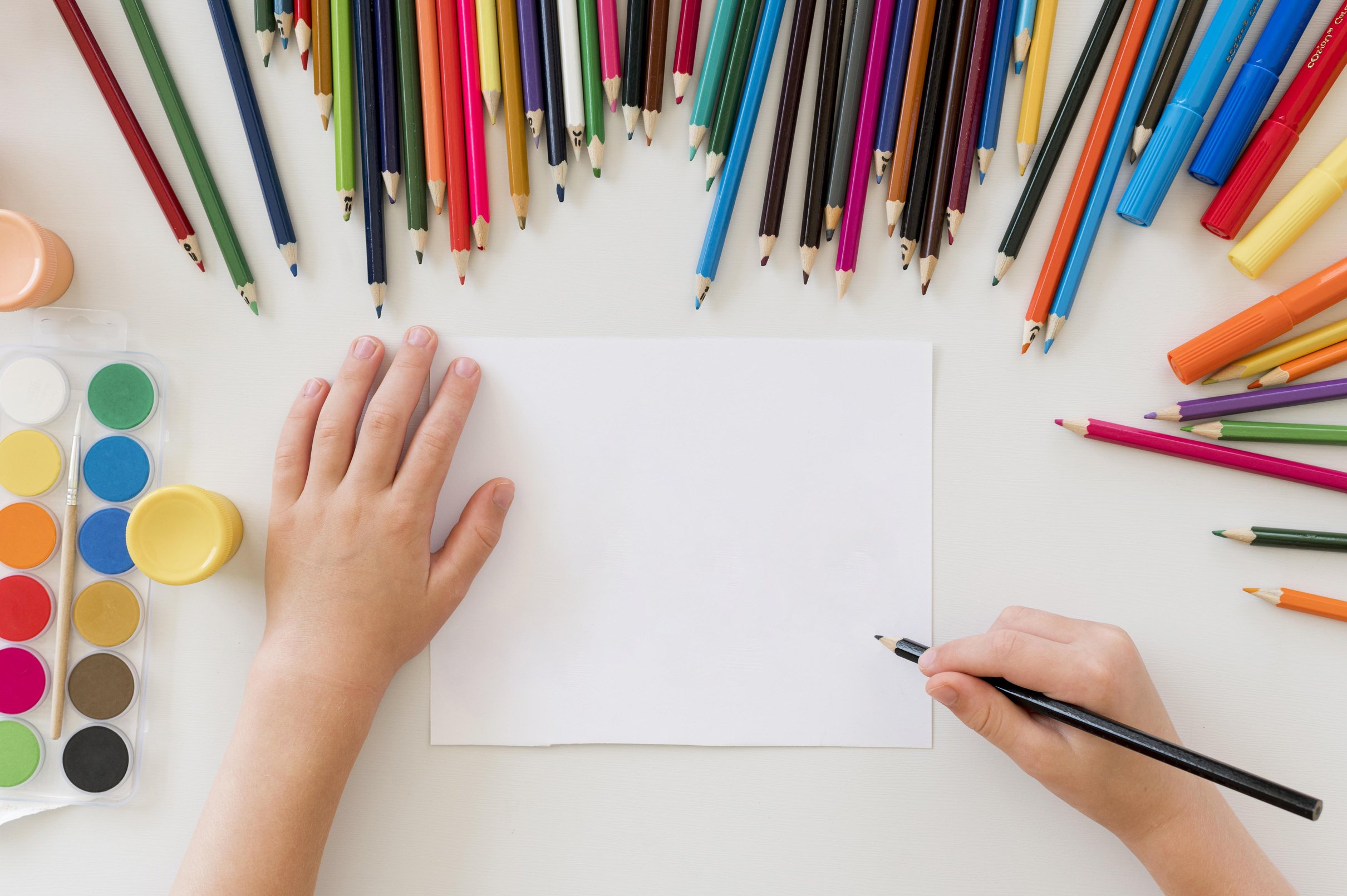 child drawing with colorful pencils